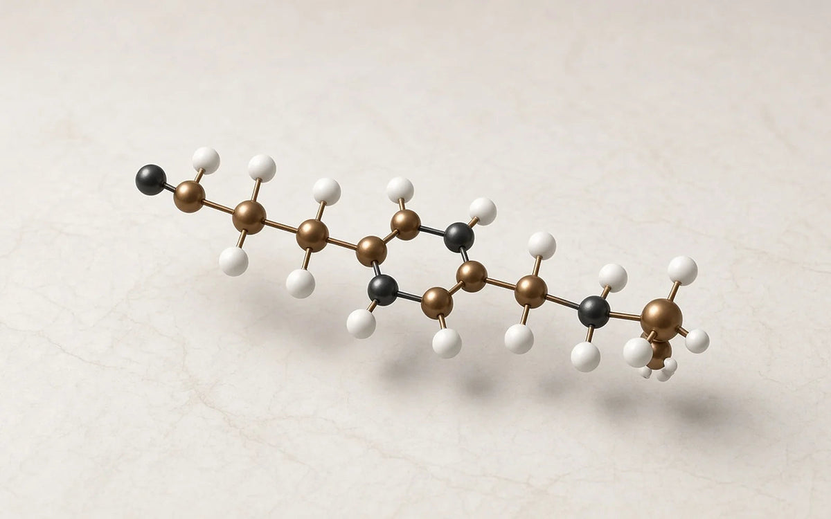Molecular model of a peptide chain resting on a pale stone surface